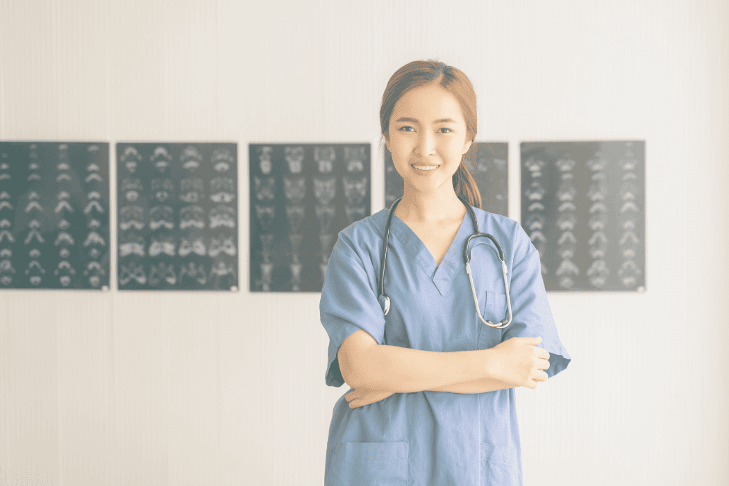 nurse with arms crossed xrays in background